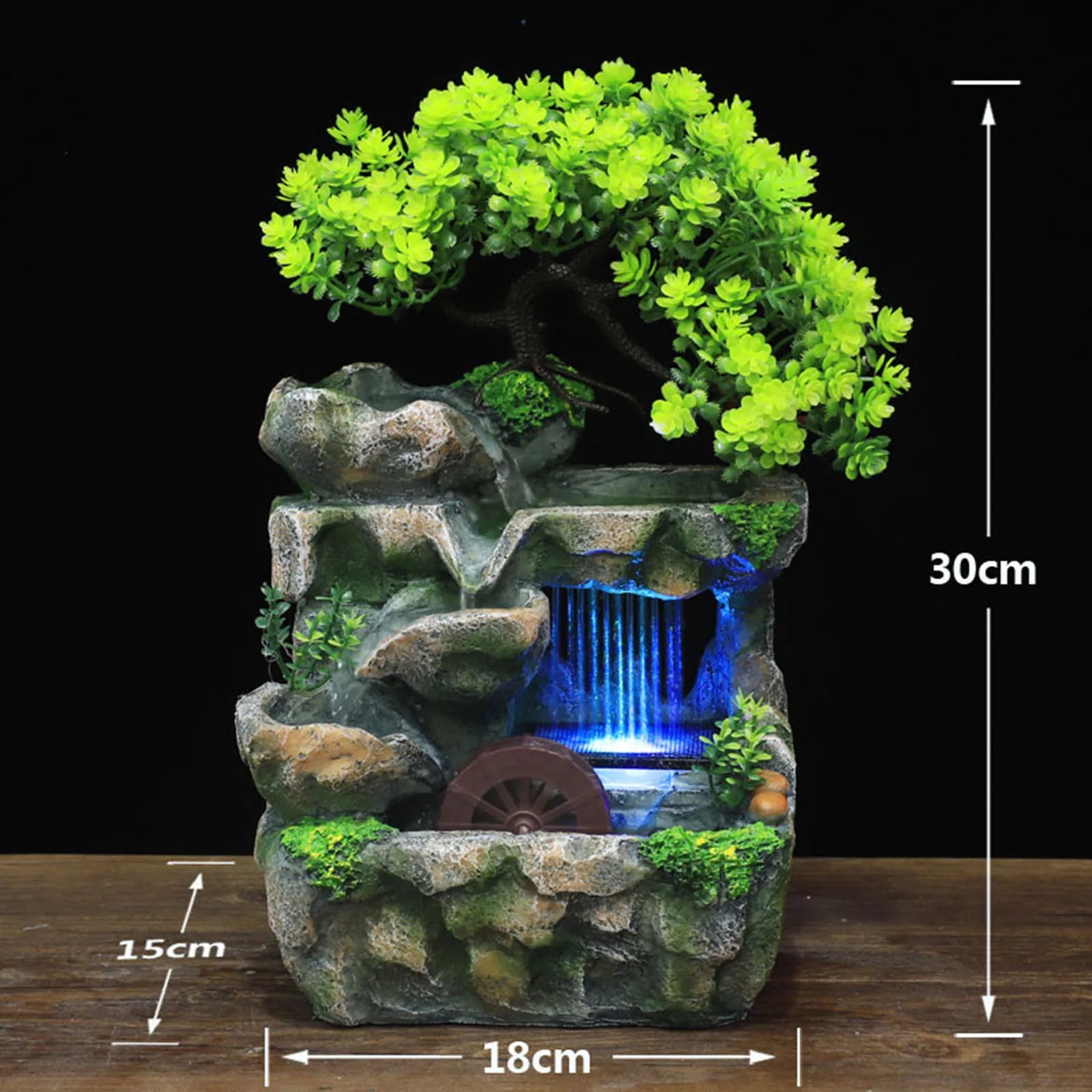 Fontana a cascata illuminata con giardino roccioso e ornamento per albero