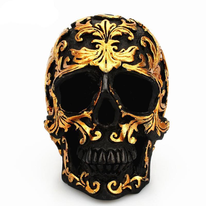 Escultura de calavera negra tallada en oro